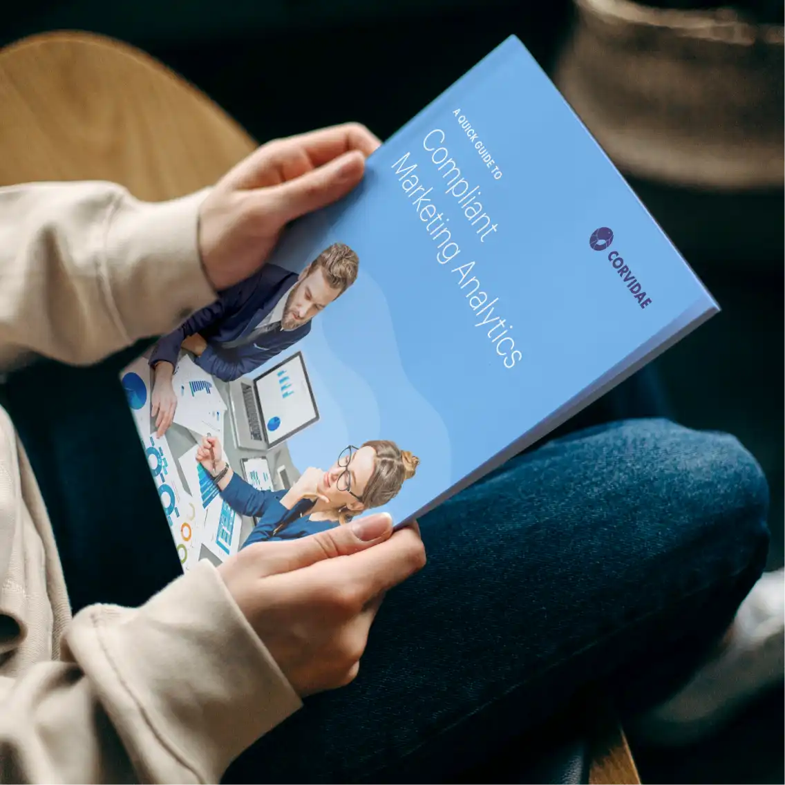 Two hands holding a printed guide booklet