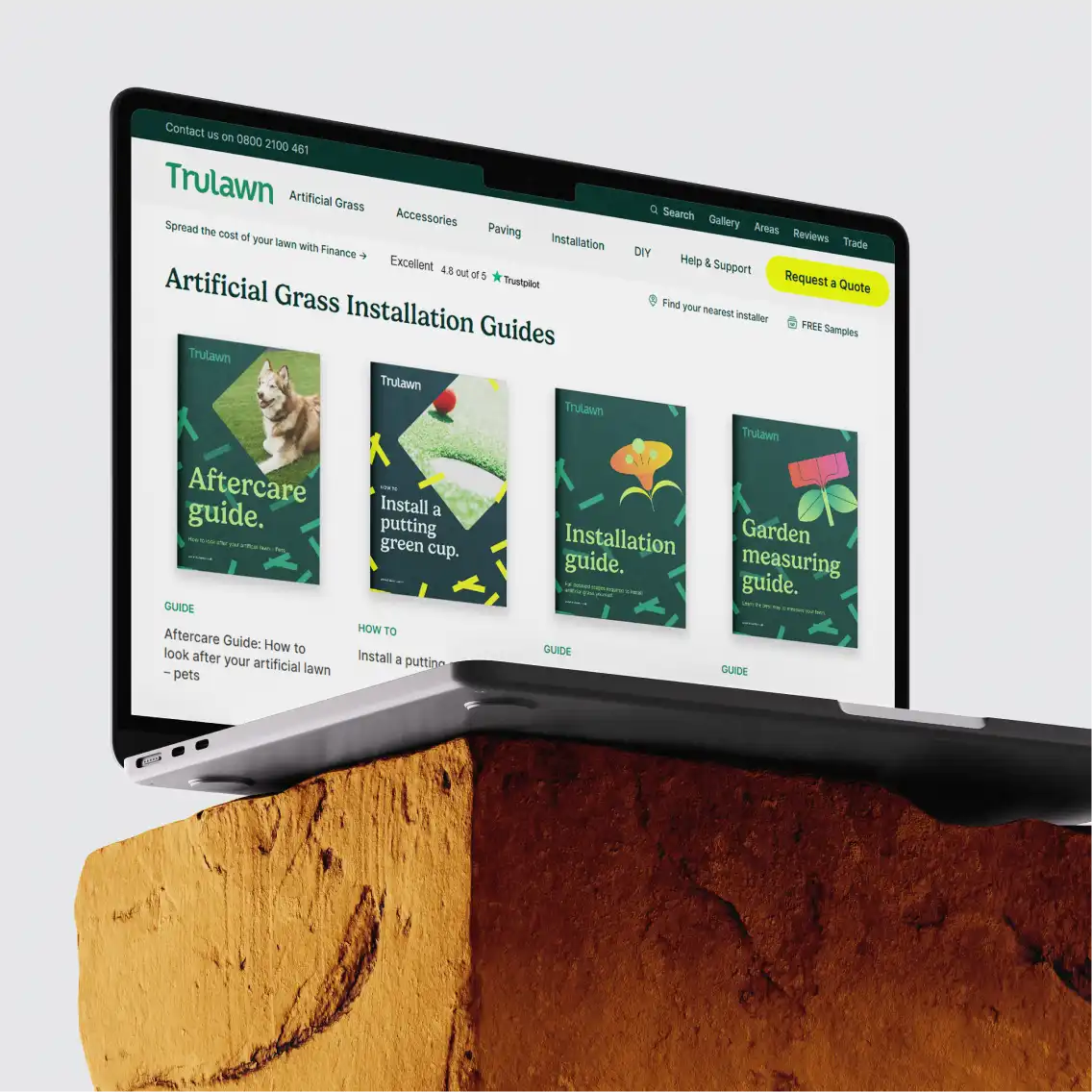 A laptop balanced on a block of stone